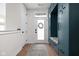Inviting mudroom with custom teal lockers, bench seating, and stylish rug, offering organization and charm at 904 Veterans Way, Carmel, IN 46032