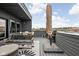 Expansive rooftop deck with a variety of seating options and an umbrella at 904 Veterans Way, Carmel, IN 46032