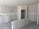 Unfinished living room with white walls, bare concrete floors and open doorway for easy customization at 9107 Steinbeck Ln, Indianapolis, IN 46239