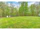 Expansive backyard with mature trees and a shed, providing plenty of space for outdoor activities at 9660 B Old Haggard Rd, Morgantown, IN 46160