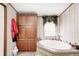 Bathroom with a built-in linen cabinet and a luxurious soaking tub with garden view at 9660 B Old Haggard Rd, Morgantown, IN 46160