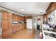 Spacious kitchen featuring wooden cabinets, ample counter space, modern appliances, and functional layout at 9660 B Old Haggard Rd, Morgantown, IN 46160