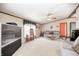 Bright and airy living room with a ceiling fan, large windows, neutral carpeting, and comfortable seating at 9660 B Old Haggard Rd, Morgantown, IN 46160