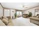 Comfortable living room featuring neutral tones, plush seating, bright windows, and a ceiling fan at 9660 B Old Haggard Rd, Morgantown, IN 46160