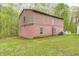 Exterior shot of a two-story outbuilding with a brick foundation and siding on the upper level at 9660 B Old Haggard Rd, Morgantown, IN 46160