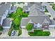 An aerial view of a charming home with well-manicured lawn, mature trees, and a paved driveway at 9713 Springcress Dr, Noblesville, IN 46060