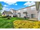 Well-maintained back yard with lush green grass, yellow bushes, and a grill for outdoor entertaining at 9713 Springcress Dr, Noblesville, IN 46060