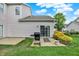 Spacious backyard with a patio, a grill, and sliding glass doors on a cloudy day at 9713 Springcress Dr, Noblesville, IN 46060