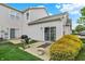 Backyard with green grass, a gray patio, a grill, and a yellow flowering bush at 9713 Springcress Dr, Noblesville, IN 46060