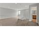 Hallway space with neutral paint and carpet, white railing and trim, and a partial bathroom view at 9713 Springcress Dr, Noblesville, IN 46060