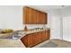 Bright kitchen featuring ample wood cabinetry, stainless sink, and complementary countertops at 9713 Springcress Dr, Noblesville, IN 46060