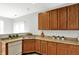 Charming kitchen featuring stainless sink, white appliances, and wood cabinetry at 9713 Springcress Dr, Noblesville, IN 46060