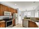 Spacious kitchen featuring stainless appliances, wood cabinets, and natural light at 9713 Springcress Dr, Noblesville, IN 46060