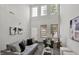 Comfortable living room with tall windows, neutral tones, and stylish decor for a cozy and inviting space at 9713 Springcress Dr, Noblesville, IN 46060