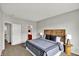 Comfortable main bedroom featuring carpeted floors, side tables with lamps, and ensuite at 9713 Springcress Dr, Noblesville, IN 46060