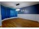 Elegant dining room with blue walls, white wainscoting, wood floors, and modern lighting at 9993 Pepper Tree Ln, Noblesville, IN 46060