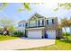 Inviting two-story home featuring a brick and siding exterior, a two-car garage, and a well-maintained front yard at 9993 Pepper Tree Ln, Noblesville, IN 46060