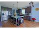 Modern kitchen with stainless steel appliances, dark cabinets, and a center island with seating at 9993 Pepper Tree Ln, Noblesville, IN 46060