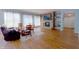 A comfortable living room featuring a stone fireplace, wood floors and bright natural light at 9993 Pepper Tree Ln, Noblesville, IN 46060