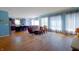 Open-concept living room with wood floors, large windows, and an adjacent kitchen area at 9993 Pepper Tree Ln, Noblesville, IN 46060