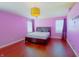 Spacious main bedroom with pink walls, hardwood floors, and a large bed at 9993 Pepper Tree Ln, Noblesville, IN 46060