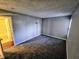 A large bedroom with carpeted floors and a light grey paint has an ensuite bathroom and a window at 10063 Penrith Dr, Indianapolis, IN 46229