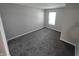 Well-lit bedroom featuring neutral walls and plush gray carpeting at 10063 Penrith Dr, Indianapolis, IN 46229