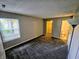This primary bedroom is spacious with a window and has access to a closet and bathroom at 10063 Penrith Dr, Indianapolis, IN 46229