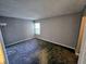 Bedroom with neutral walls, gray carpet, and natural light from the window at 10063 Penrith Dr, Indianapolis, IN 46229