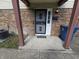 Close-up of a front entrance with a secure black door, brick facade, and address numbers at 10063 Penrith Dr, Indianapolis, IN 46229