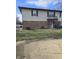 Two-story townhouse with brick and siding, featuring a small balcony and front yard at 10063 Penrith Dr, Indianapolis, IN 46229