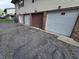 The parking lot of the apartments has one row of private garages for tenants and guest parking at 10063 Penrith Dr, Indianapolis, IN 46229