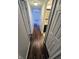 The well-lit hallway has luxury vinyl flooring, access to a bathroom and an additional bedroom at 10063 Penrith Dr, Indianapolis, IN 46229