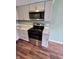 Well-equipped kitchen featuring stainless steel appliances, modern countertops, and gray cabinets at 10063 Penrith Dr, Indianapolis, IN 46229