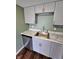 Close-up of a kitchen sink with stainless steel appliances, light gray cabinets, and a modern faucet at 10063 Penrith Dr, Indianapolis, IN 46229
