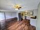 Open-concept living and kitchen space with modern appliances and stylish dark wood flooring at 10063 Penrith Dr, Indianapolis, IN 46229