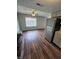 Open-concept living and kitchen space featuring dark wood floors, gray walls, and modern appliances at 10063 Penrith Dr, Indianapolis, IN 46229