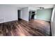 Bright living room with dark wood floors, neutral walls, and open to a modern kitchen at 10063 Penrith Dr, Indianapolis, IN 46229