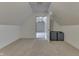 Finished attic space leading into another room; suitcases on the floor suggest storage at 1014 Massey Ct, Greenwood, IN 46143