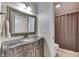 Bathroom vanity with a stylish mirror and a view into an adjacent toilet and shower area at 1014 Massey Ct, Greenwood, IN 46143