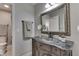 Bathroom vanity with a stylish mirror and a view into an adjacent toilet and shower area at 1014 Massey Ct, Greenwood, IN 46143