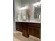 Modern bathroom featuring double vanity with dark wood cabinets and framed mirrors at 1014 Massey Ct, Greenwood, IN 46143