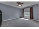This bedroom features modern ceiling fan, plush carpet, neutral tones, and good natural light at 1014 Massey Ct, Greenwood, IN 46143