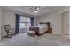 Carpeted bedroom with ceiling fan, rocking chair, and a window bringing in natural light at 1014 Massey Ct, Greenwood, IN 46143