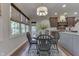 Eat-in kitchen boasts hardwood floors, a black dining table, and windows for natural light at 1014 Massey Ct, Greenwood, IN 46143