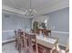 Cozy dining area featuring a wooden table with eight chairs and a chandelier hanging overhead at 1014 Massey Ct, Greenwood, IN 46143