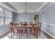 Elegant dining room featuring a wooden table with seating for eight beneath a decorative chandelier at 1014 Massey Ct, Greenwood, IN 46143