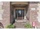Elegant front door with sidelights, decorative accents, brick facade, and a welcoming entrance at 1014 Massey Ct, Greenwood, IN 46143