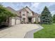 Beautiful brick home featuring a three-car garage, well-manicured lawn, and tasteful landscaping at 1014 Massey Ct, Greenwood, IN 46143