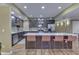 Well-lit kitchen with stainless appliances, a large central island with bar seating, and sleek cabinetry at 1014 Massey Ct, Greenwood, IN 46143